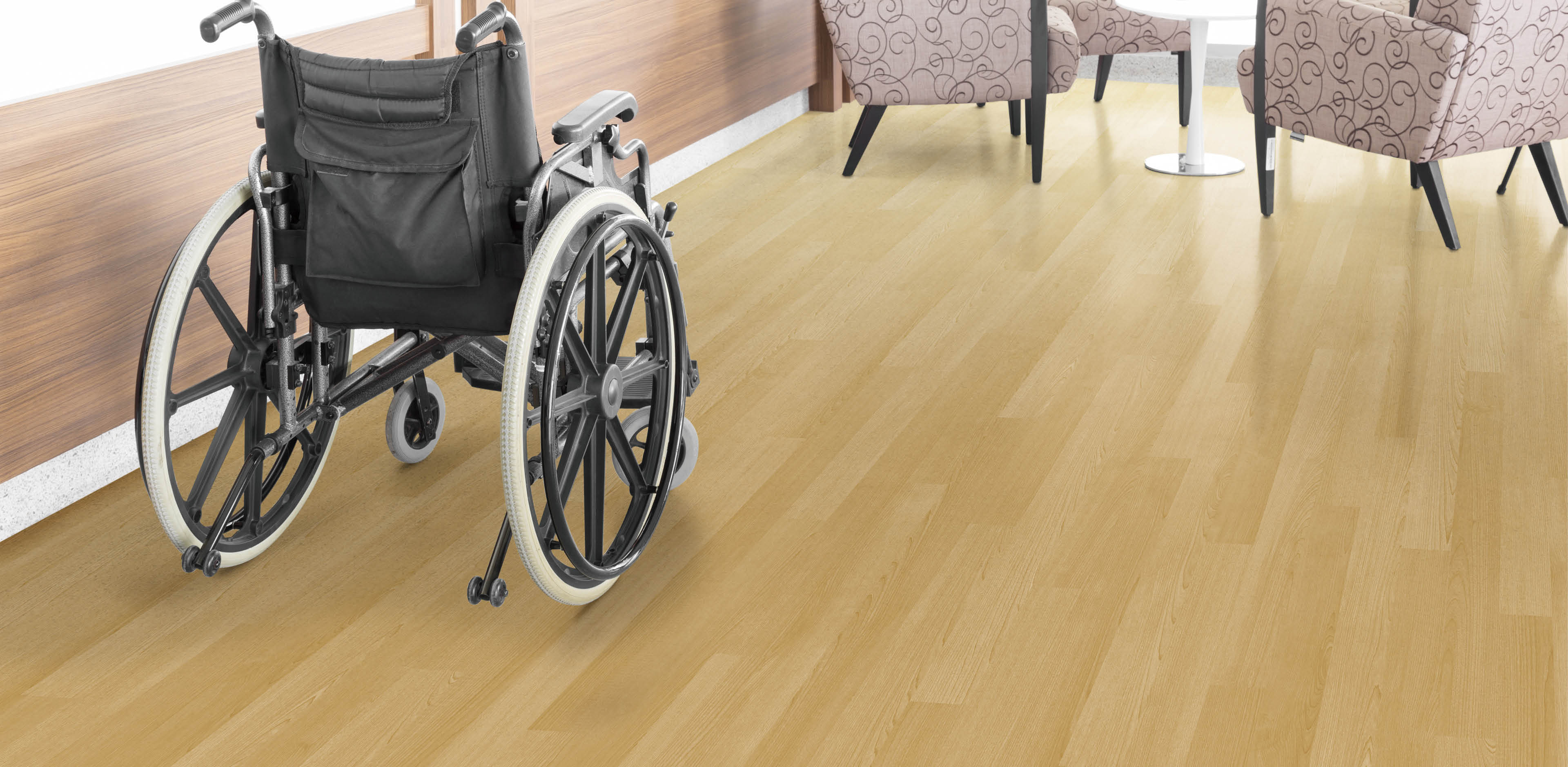 Empty wheelchair parked in hospital hallway