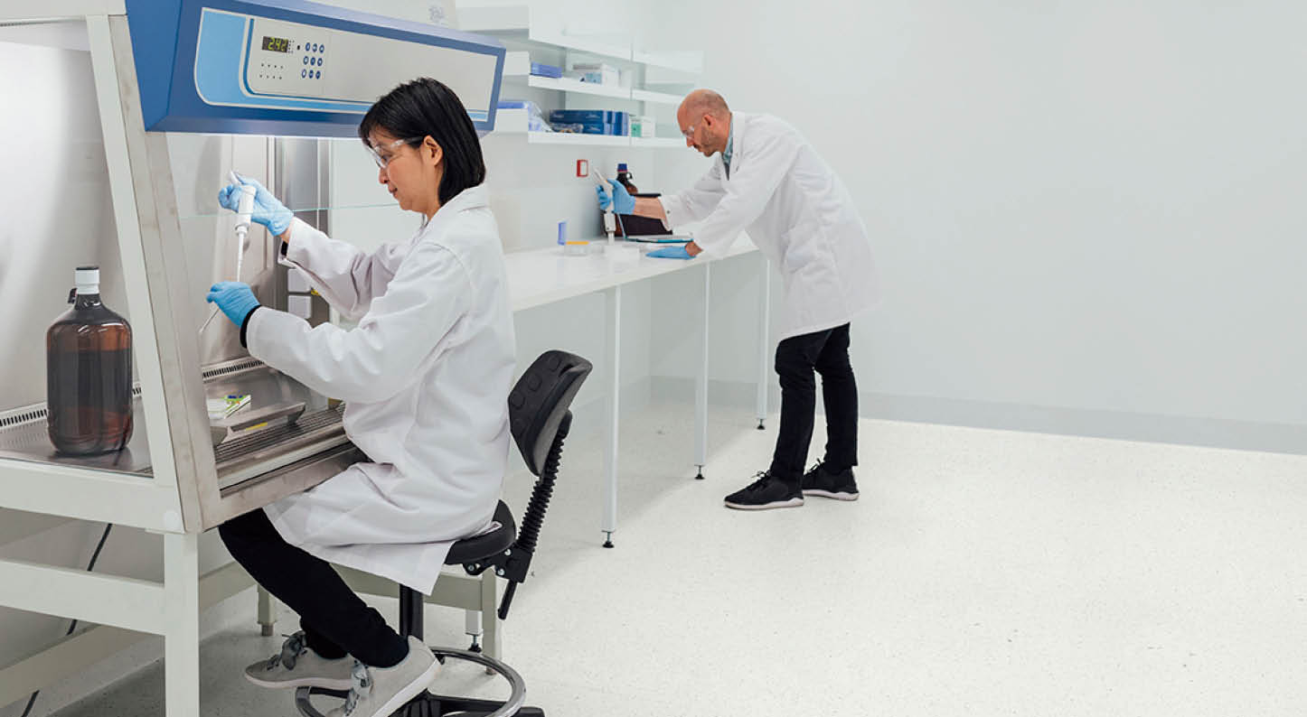 Patient personal health care taken by a specialist biochemist in a research facility being examined by two biochemists 