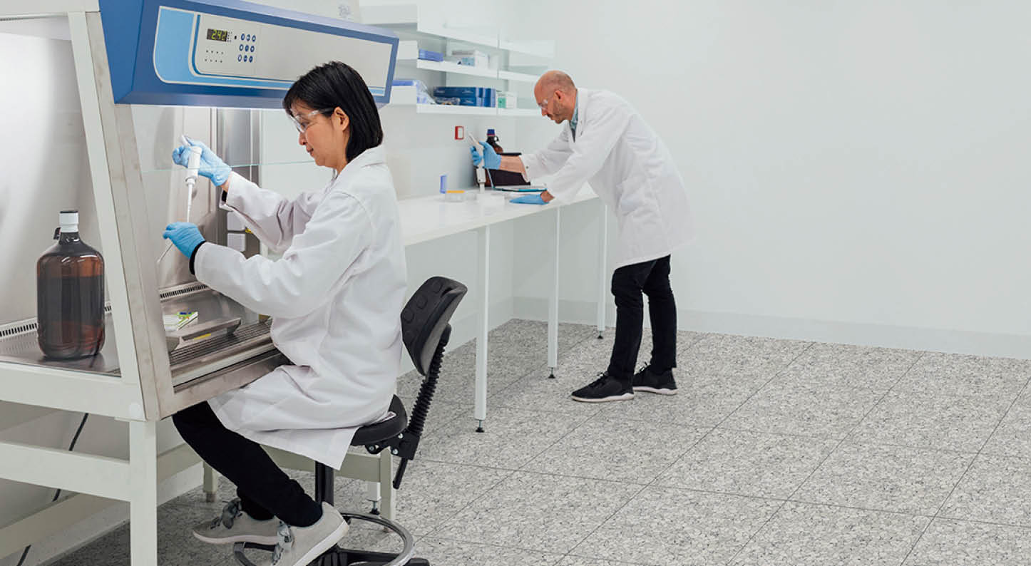 Patient personal health care taken by a specialist biochemist in a research facility being examined by two biochemists 